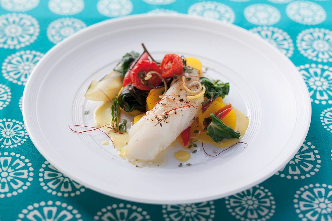 Cod with vegetables, lemon sauce and chili strings