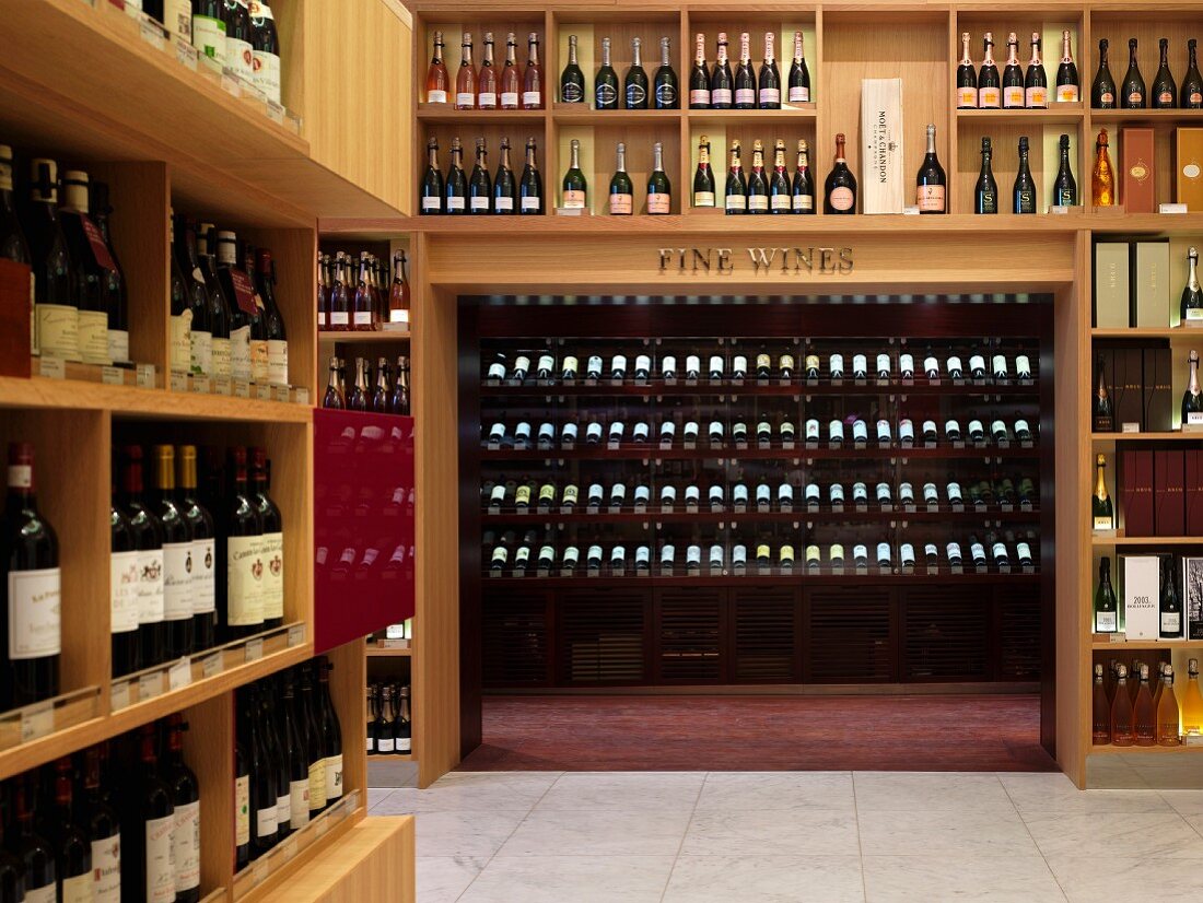Premises of upmarket wine retailer with floor-to-ceiling wooden wine racks