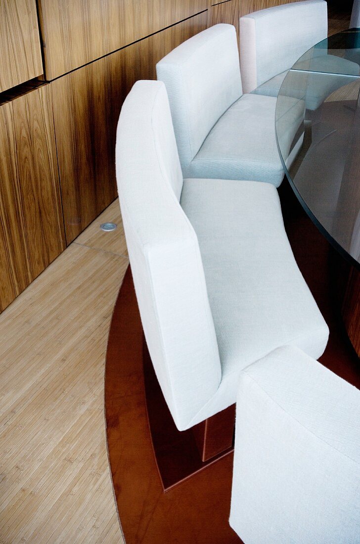 Elegant, upholstered benches around a glass table