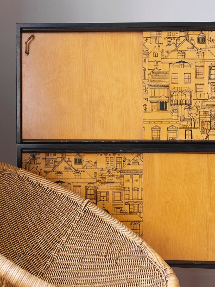 Bambussessel vor einem Wandschränkchen