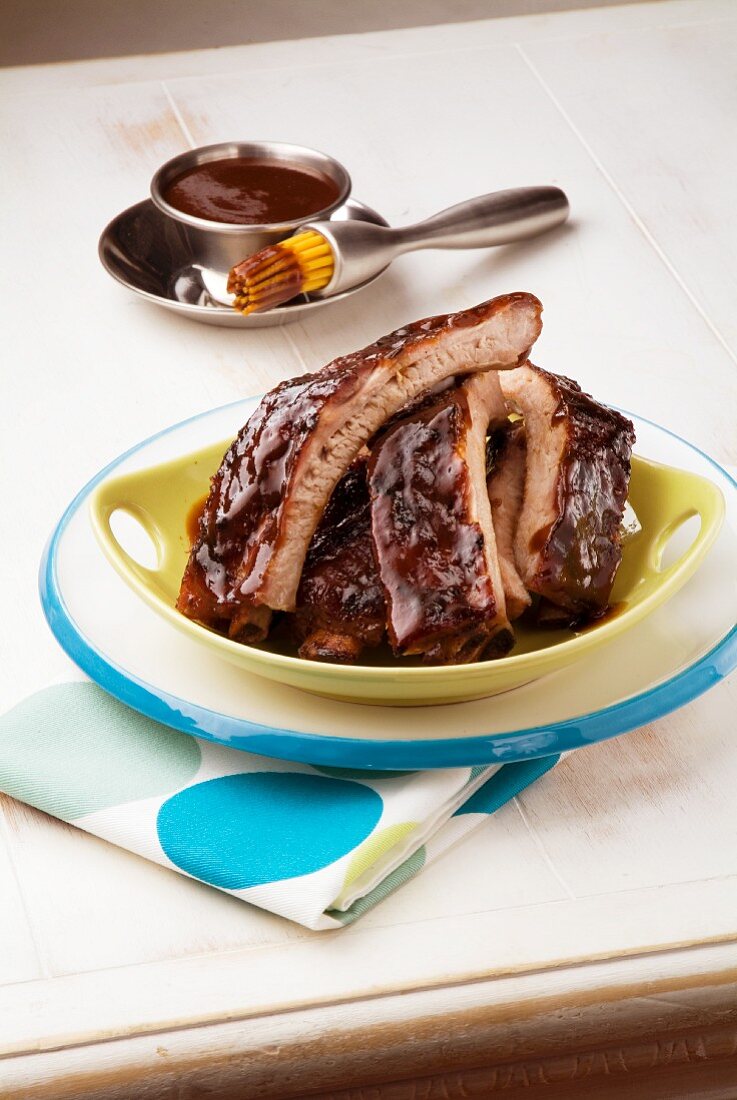 Dish of Barbecue Pork Ribs; Barbecue Sauce with Basting Brush
