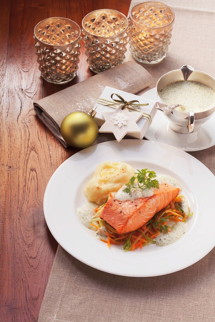 Salmon with a herbal foam sauce and carrot strips