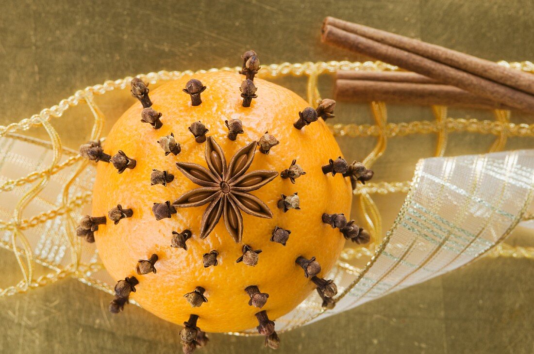 An orange pierced with cloves and an anise star