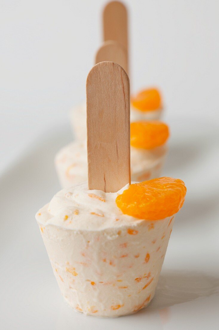 Homemade mandarin ice cream on sticks
