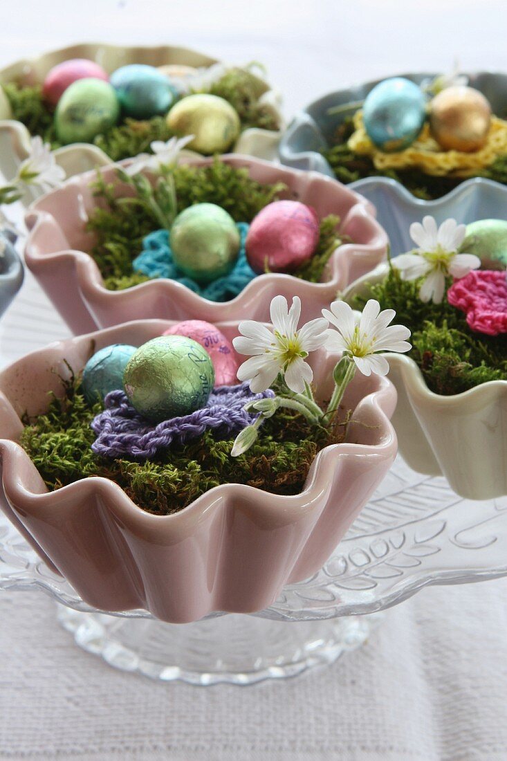 Chocolate eggs on moss in ceramic cupcake cases