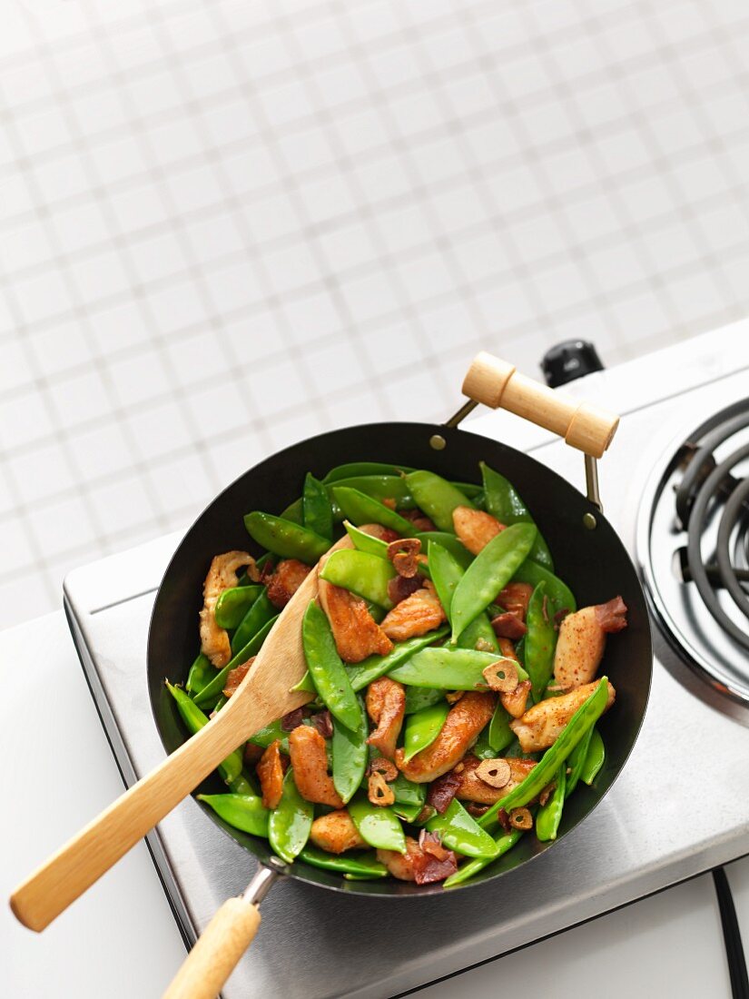 Chicken and mange tout in a wok