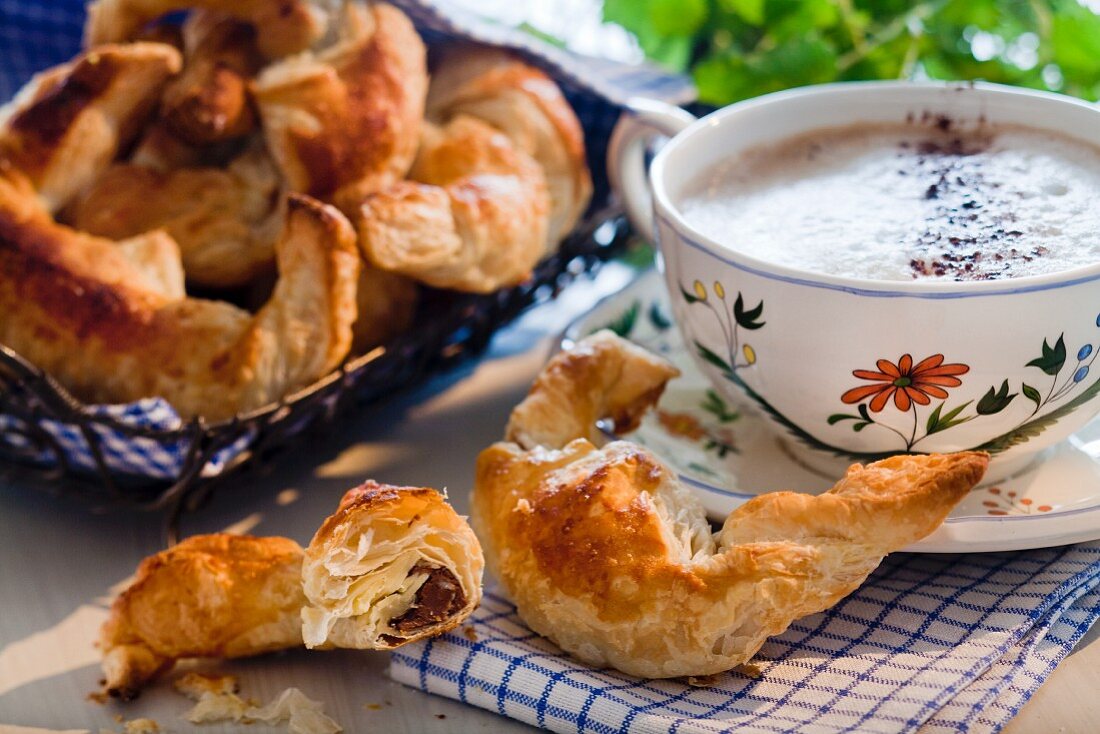 Chocolate croissant and cup of cappuccino