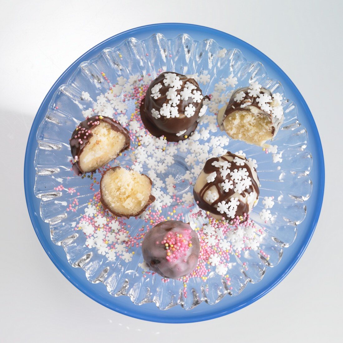 Petit fours with chocolate icing, sugar pearls and snowflakes