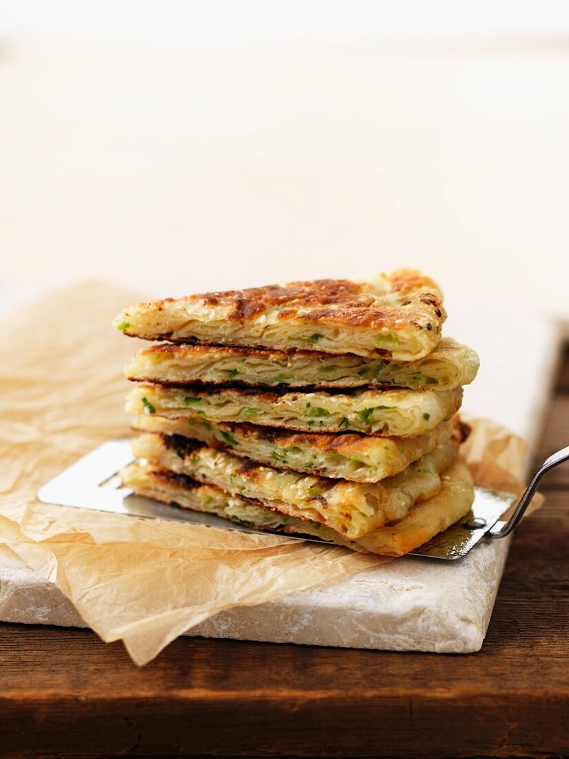 Chinese pancakes with spring onions on a cake slice