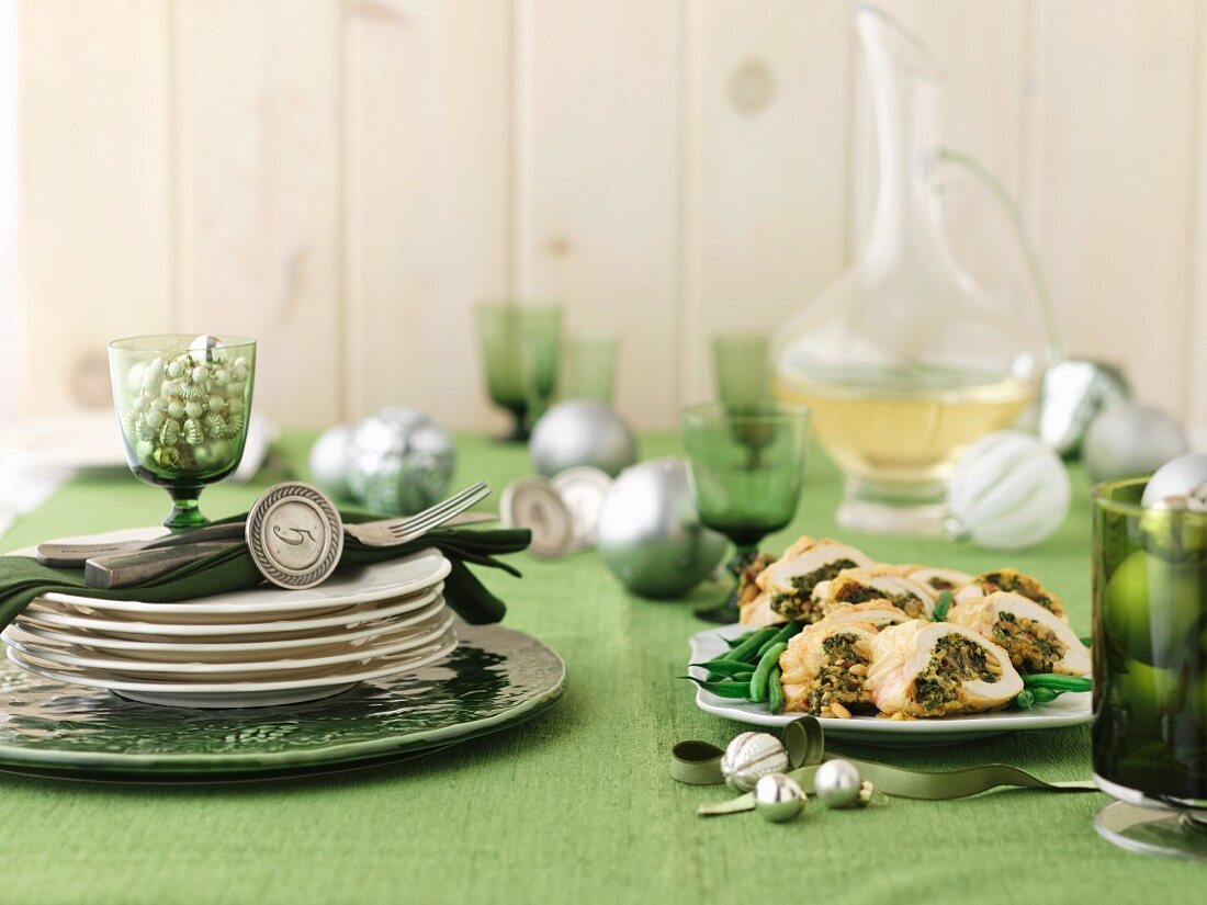 Stuffed chicken on a table laid for Christmas dinner