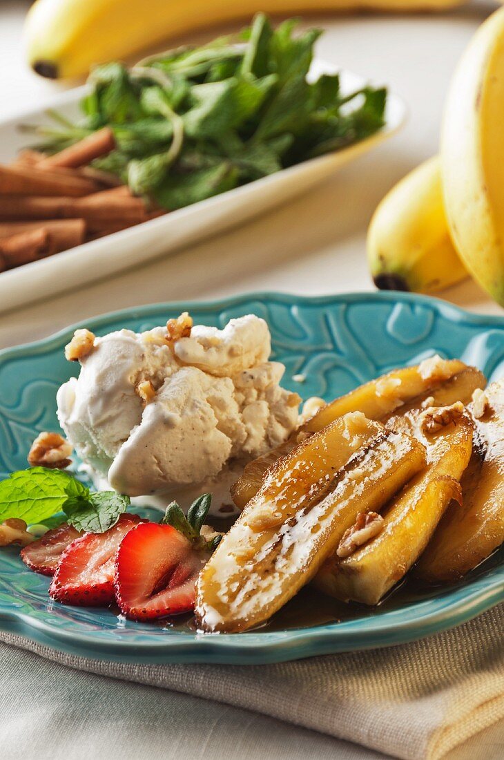 Bananas Foster with Walnuts, Strawberries, Vanilla Ice Cream and a Mint Garnish