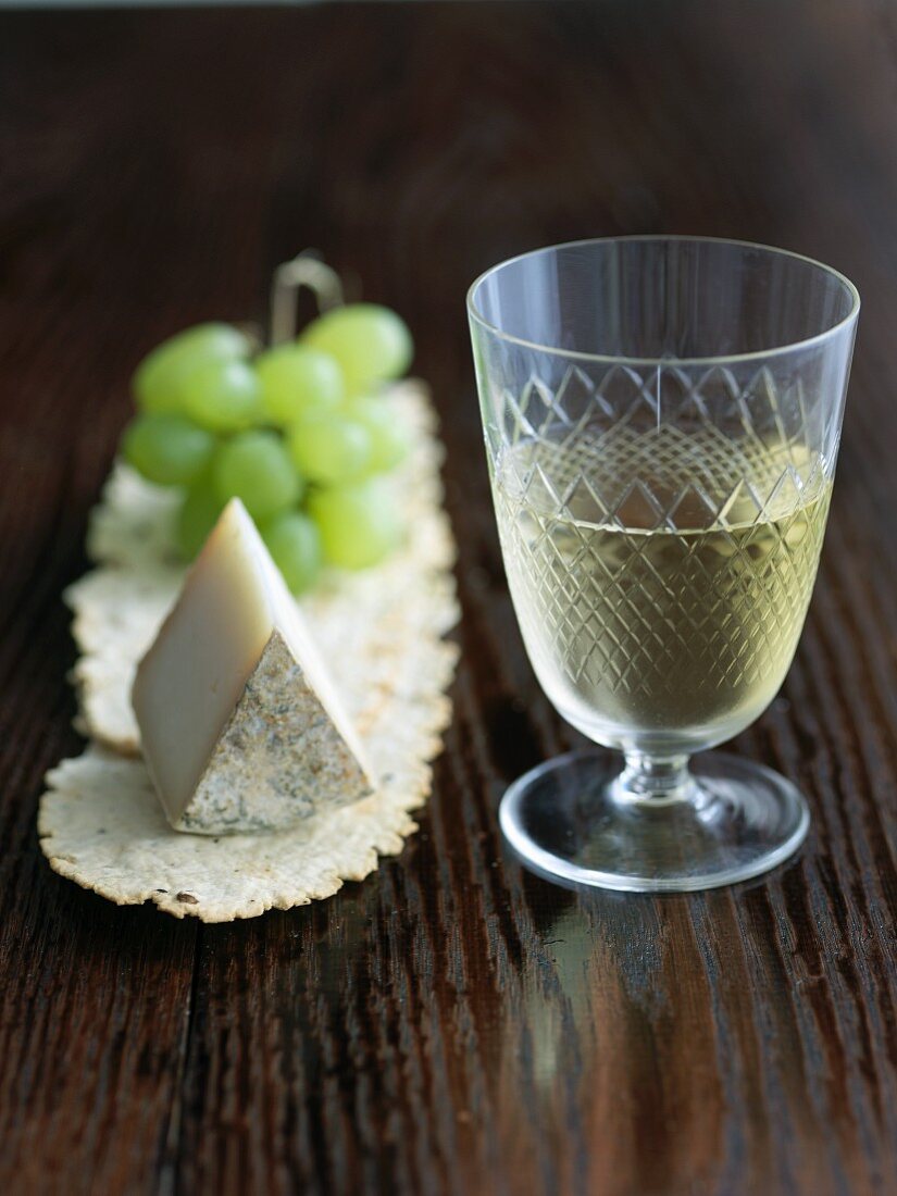 Glass of White Wine with a Wedge of Aged Goat Cheese and Green Grapes
