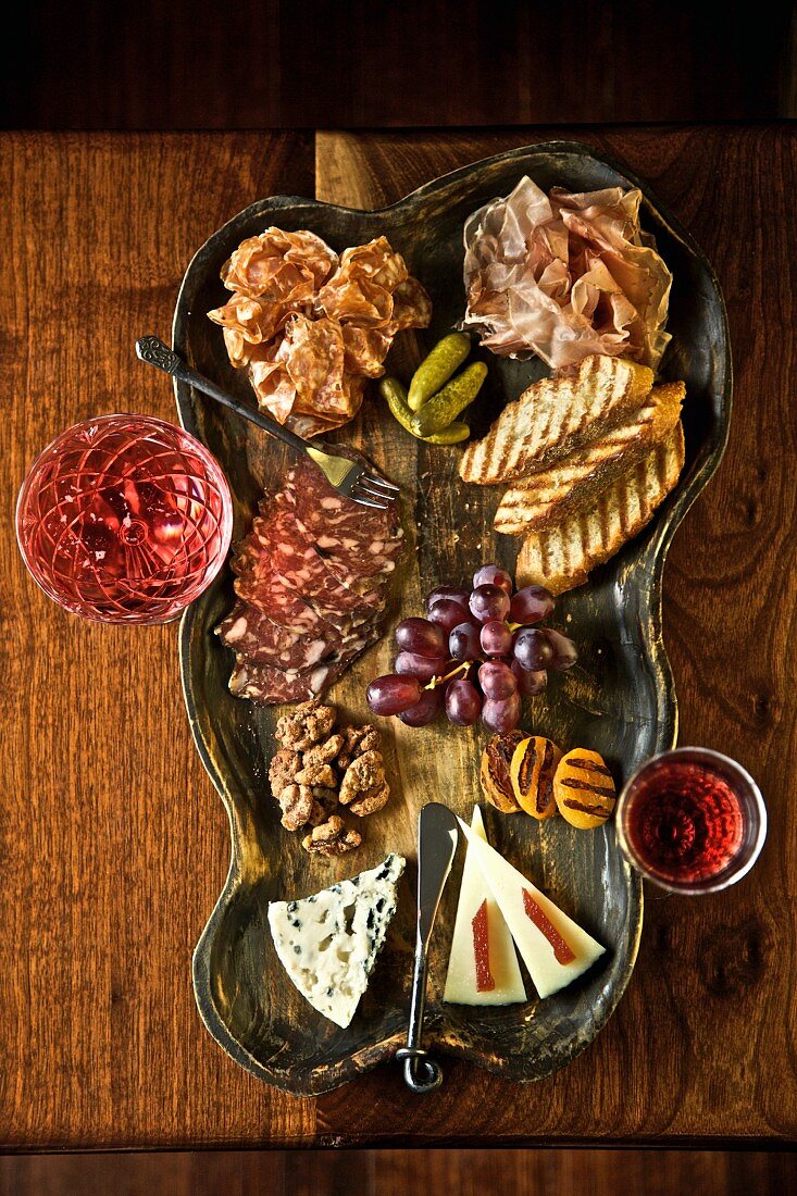 Appetizer Platter with Cheese, Salami, Nuts and Fruit; Red Wine