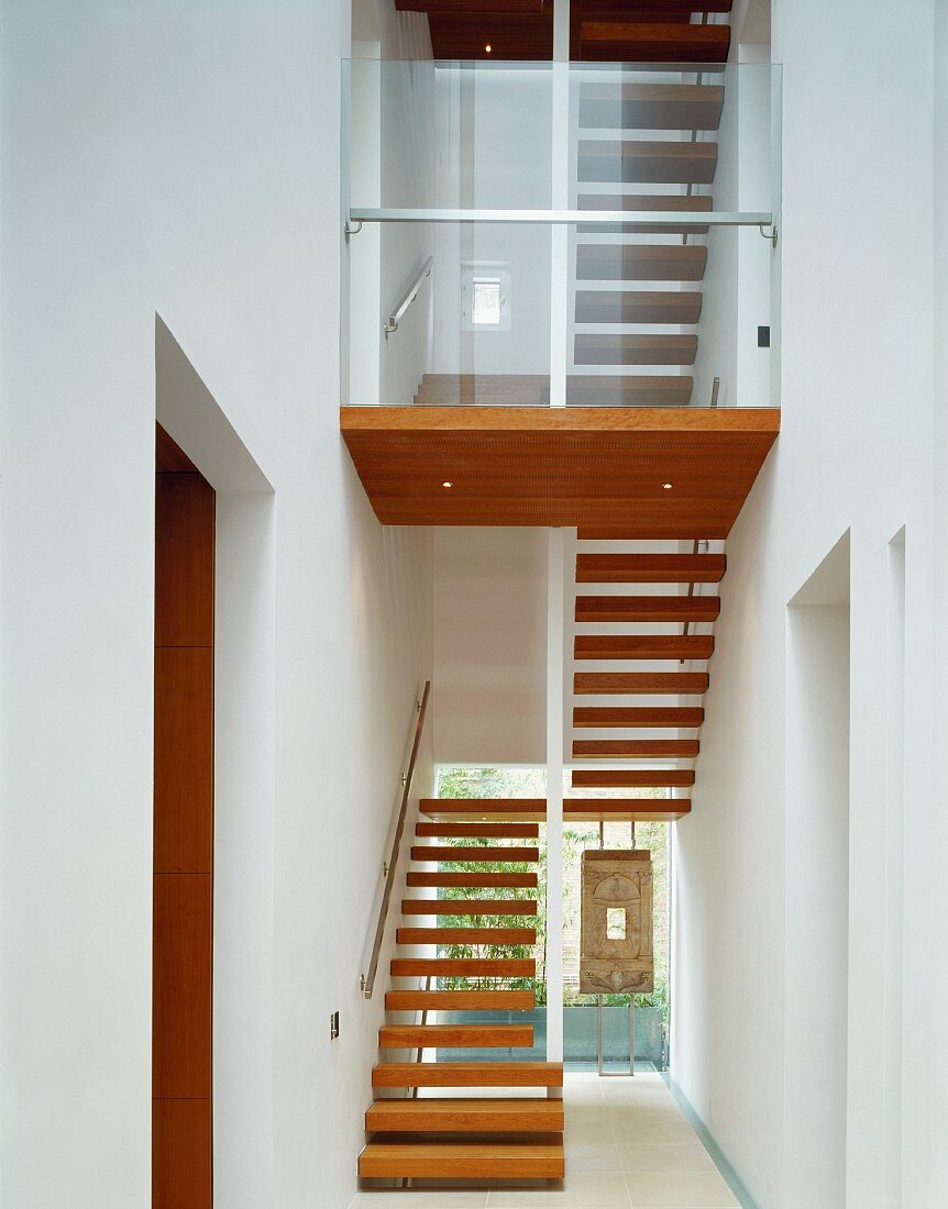 Modern, white stairwell with wooden stair treads