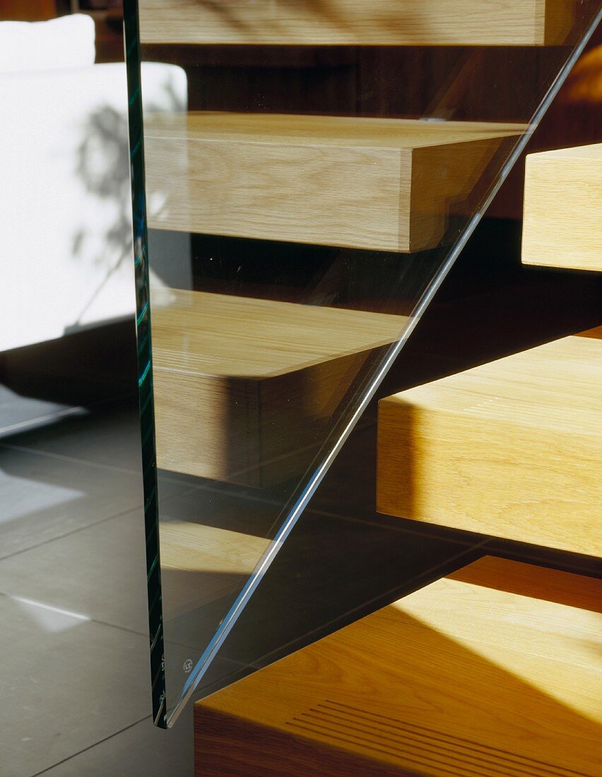 Detail of wooden stair treads and glass balustrade