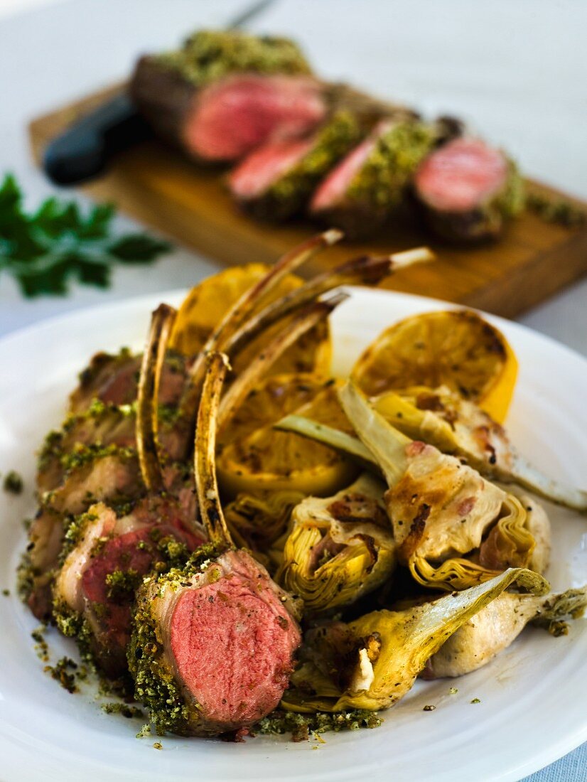 Barbecue lamb chops with artichokes and lemon halves