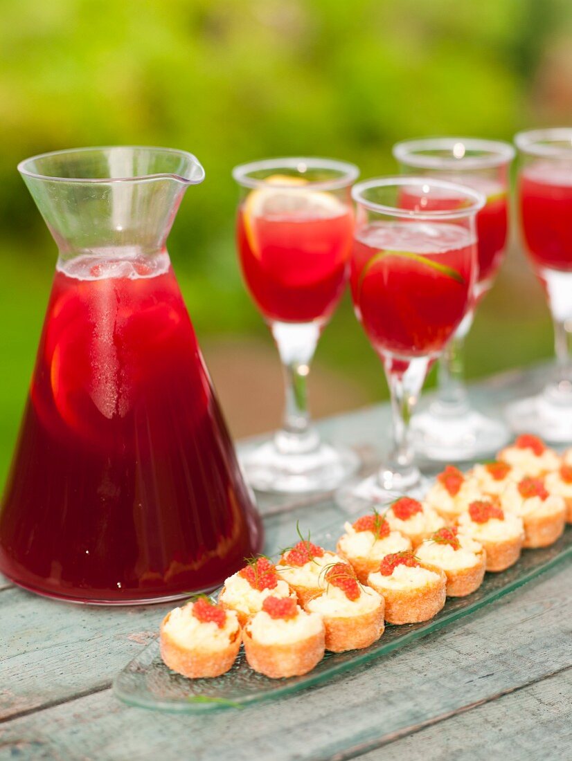 Sangria and potato and cheese pastries with caviar