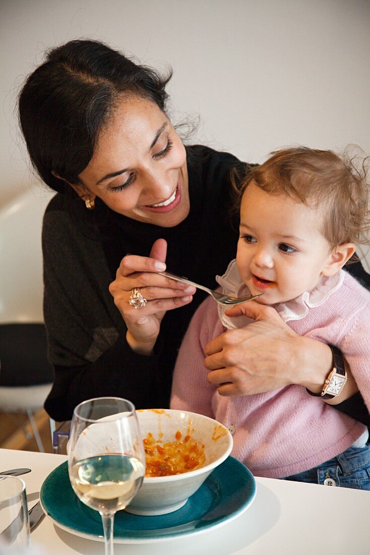 Mother feeding her daughter