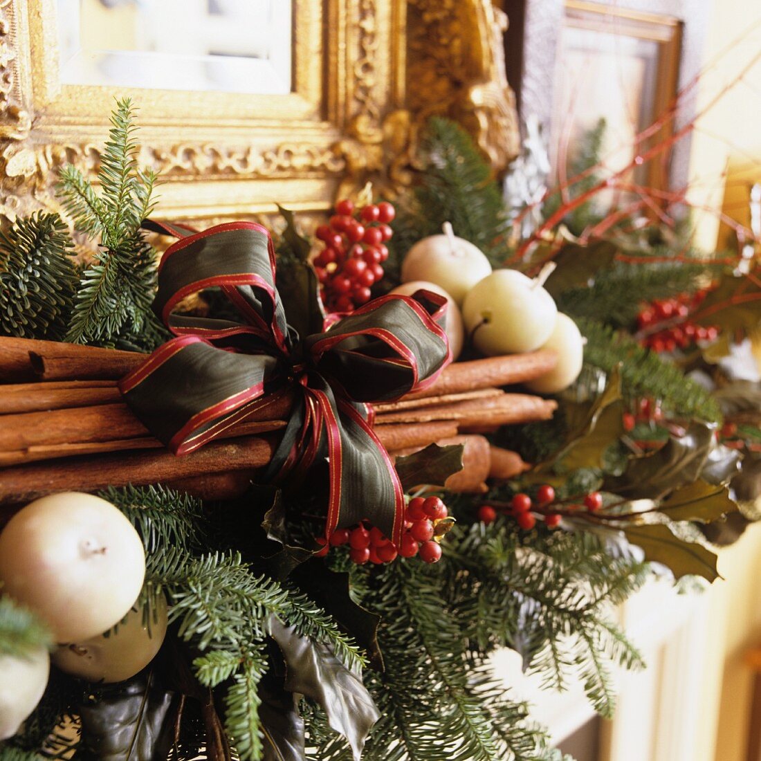 Christmas arrangement with cinnamon sticks and bow