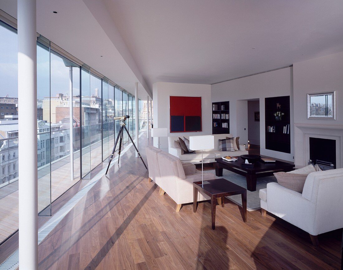 Modern living room with large glass windows in a penthouse apartment