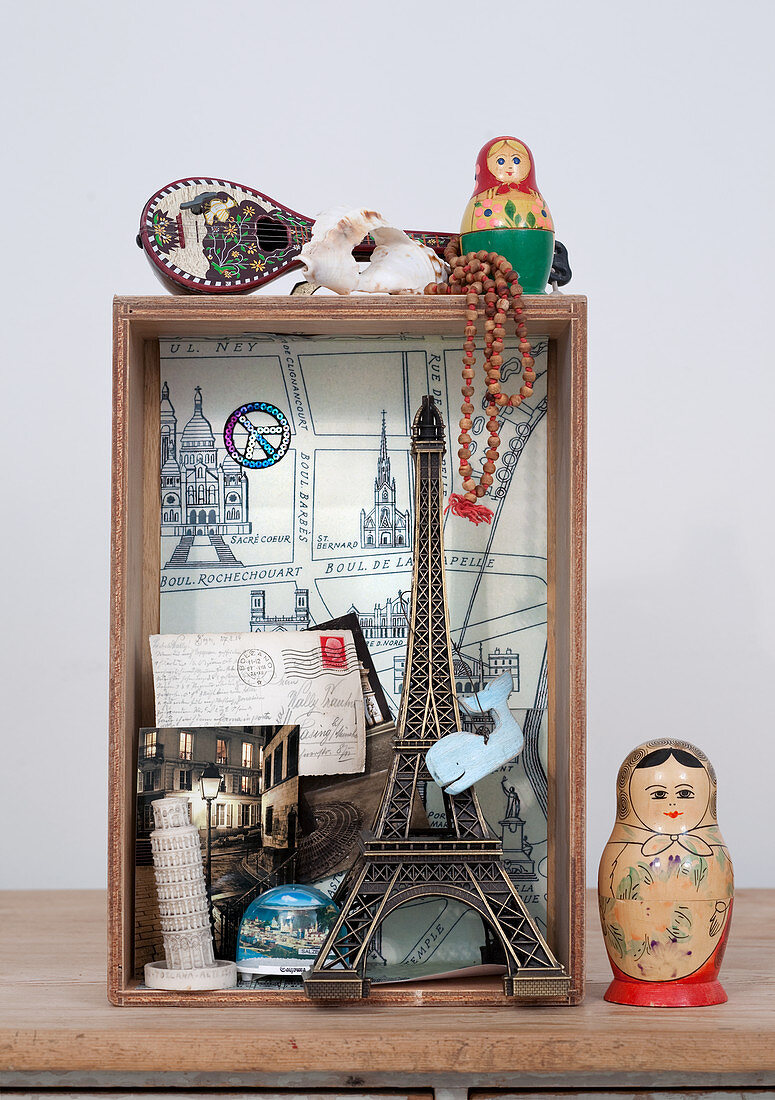 Small display case of souvenirs and Russian doll (Matryoshka) on table