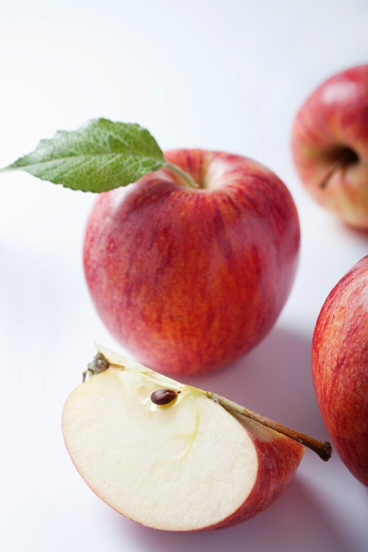 An apple wedge and whole apples