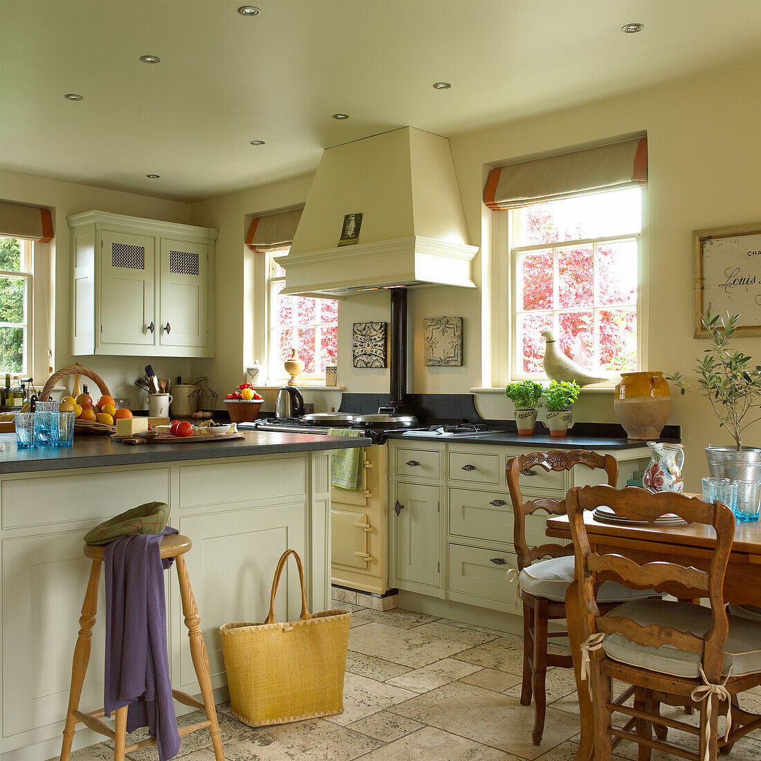 Country kitchen with light-coloured cupboards and dining table