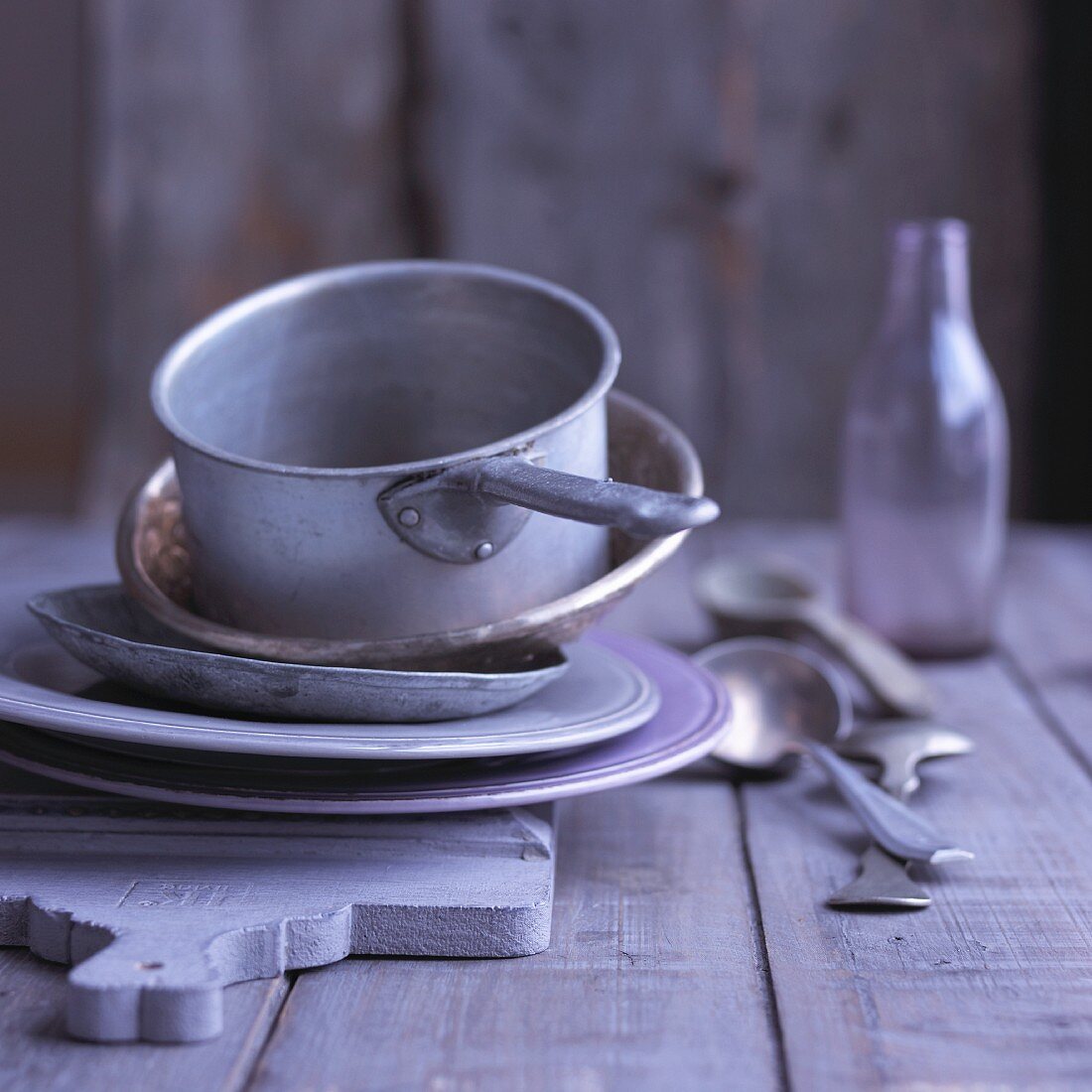 Old pots and plates on a chopping board