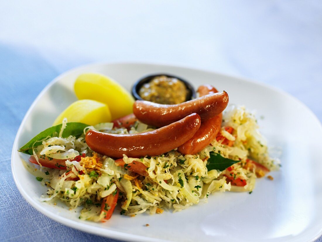 Sausages with cabbage salad, mustard and potatoes