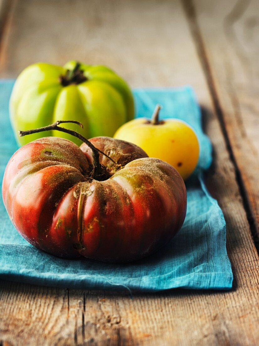 Heirloom tomatoes on a blue cloth