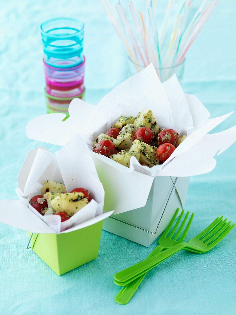 Potato salad with cherry tomatoes in a take-away box