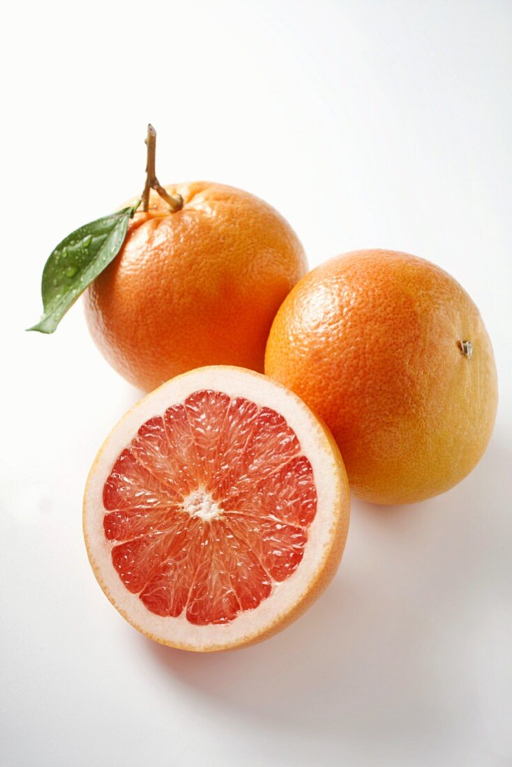 Pink grapefruits, whole and halved