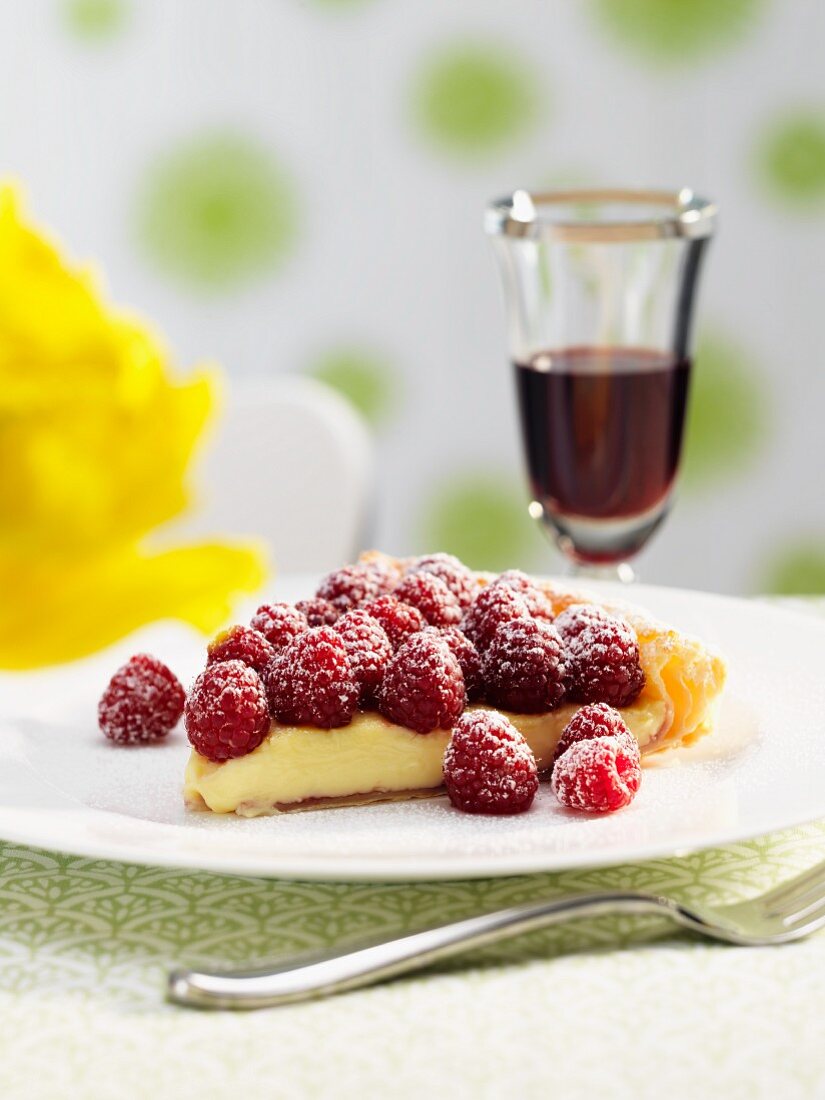 A piece of white chocolate tart with raspberries