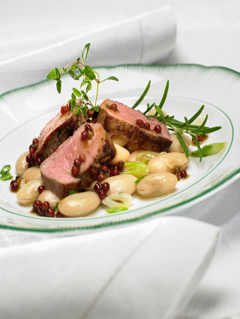 Saddle of lamb on a bed of bean salad