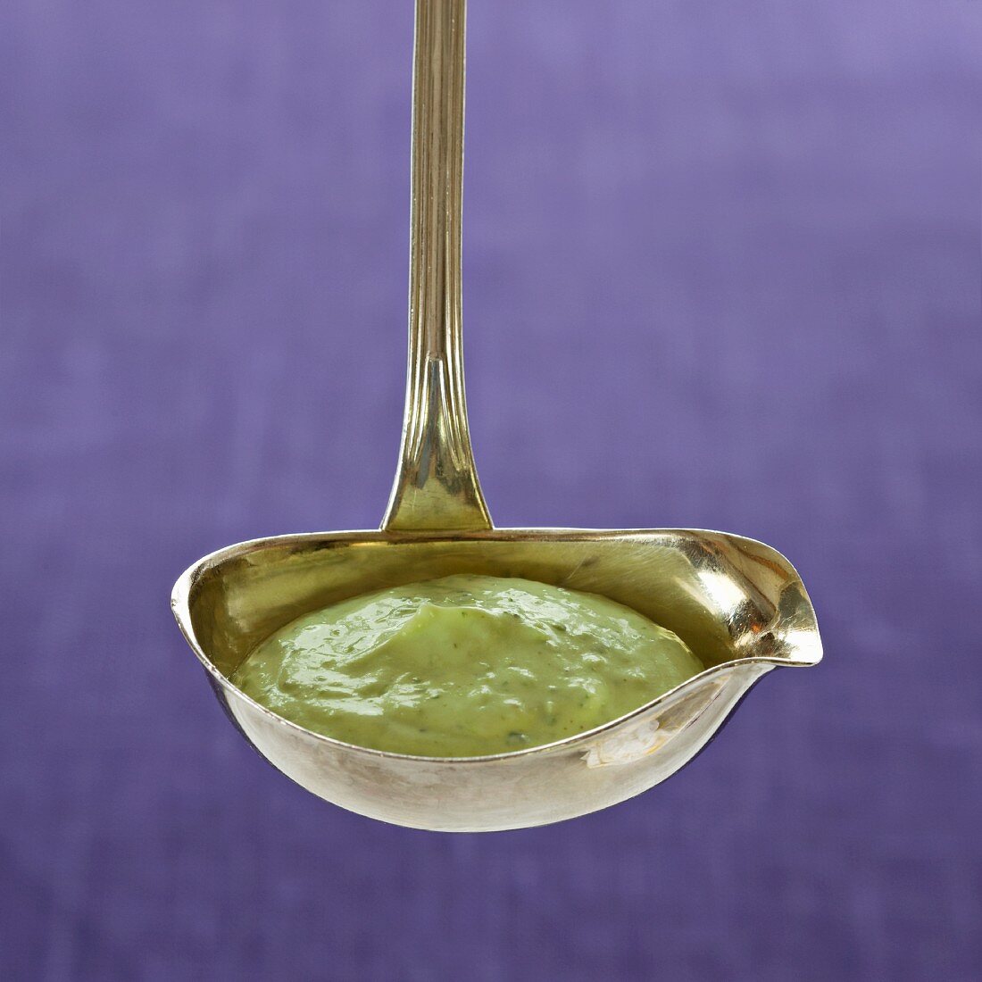 Herb yogurt sauce in a ladle