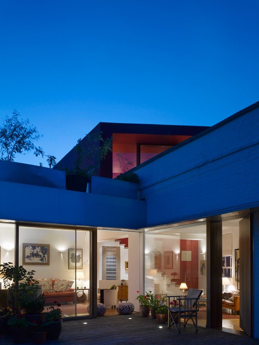 House with terrace & roof garden at dusk