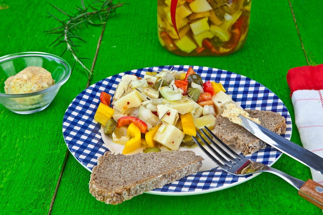 A supper of Swiss cheese, pickled in vegetables and olive oil with herb butter
