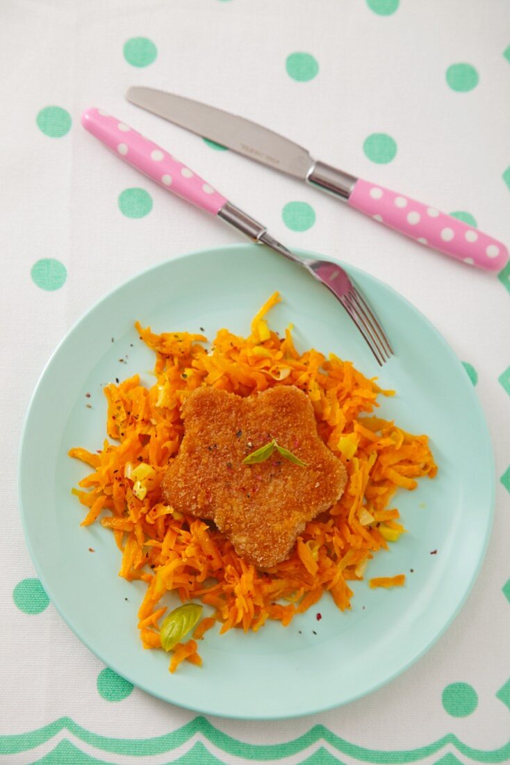 Star-shaped fish patty with grated carrots