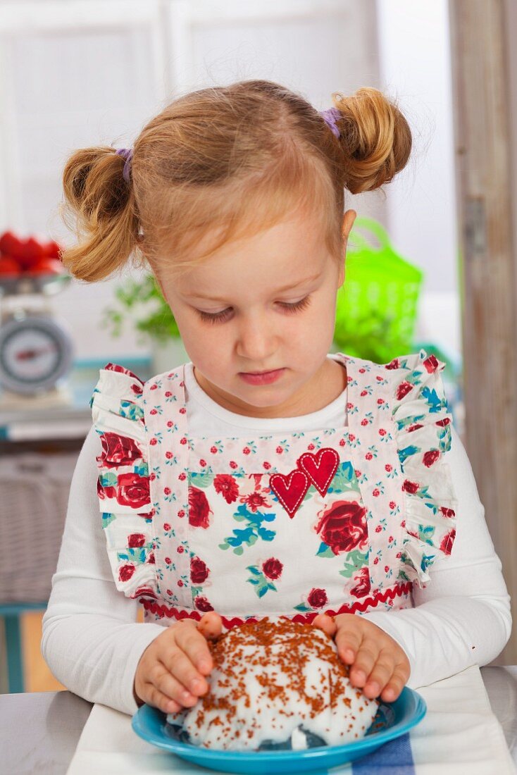 Little girl putting cress seeds on a cotton pad