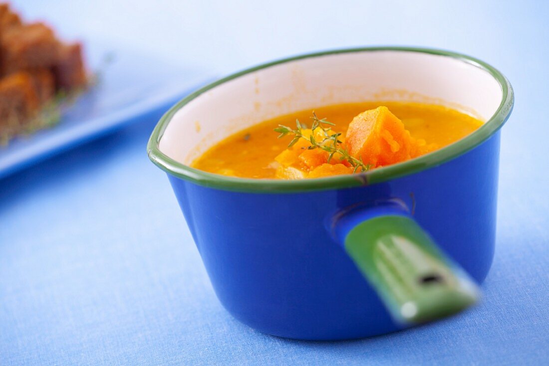 Pumpkin soup in a blue pot