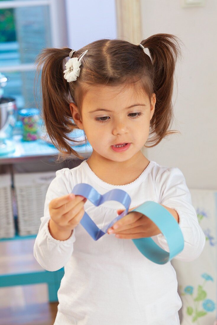 A little girl holding cutters