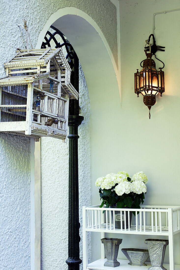 White hydrangeas, lamp and vintage birdcage