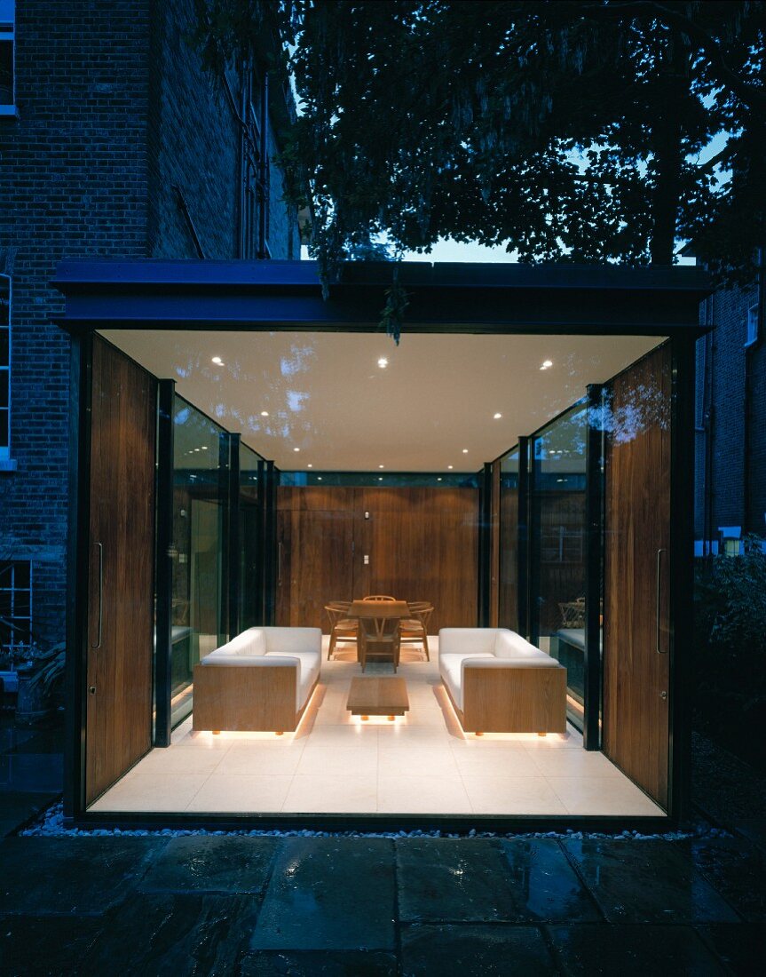 Glazed extension and illuminated interior at dusk