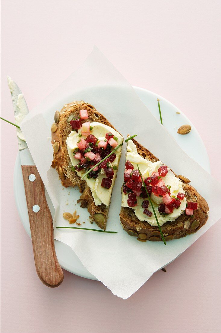 A slice of wholemeal bread topped with horseradish and beetroot