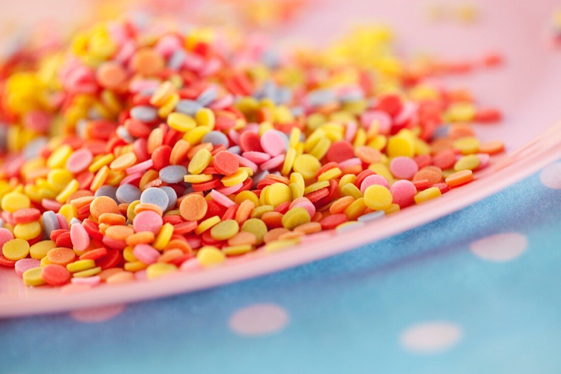 A plate of colourful sugar sprinkles (close-up)
