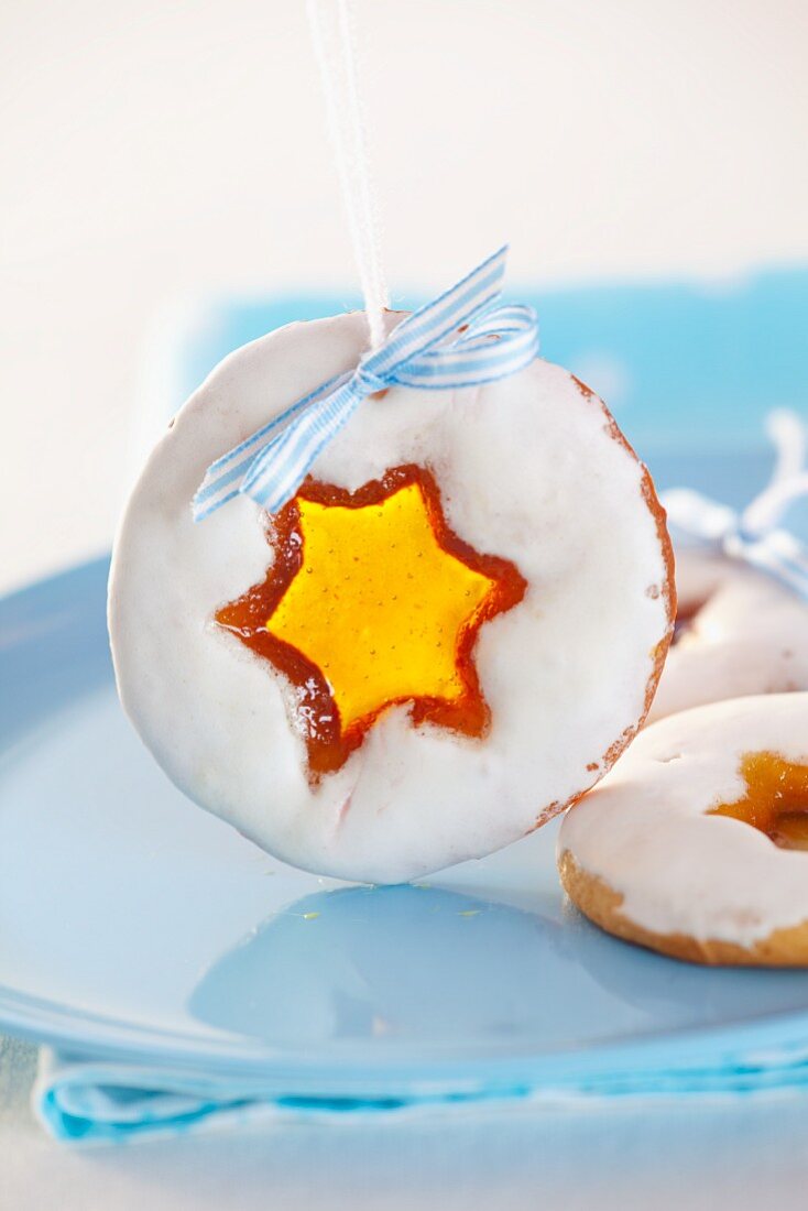 Christmas biscuits with star-shaped candy-filled holes