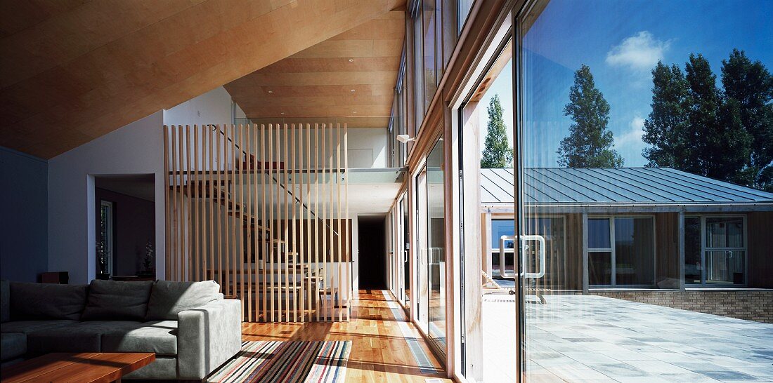 Living room with glass wall leading to terrace