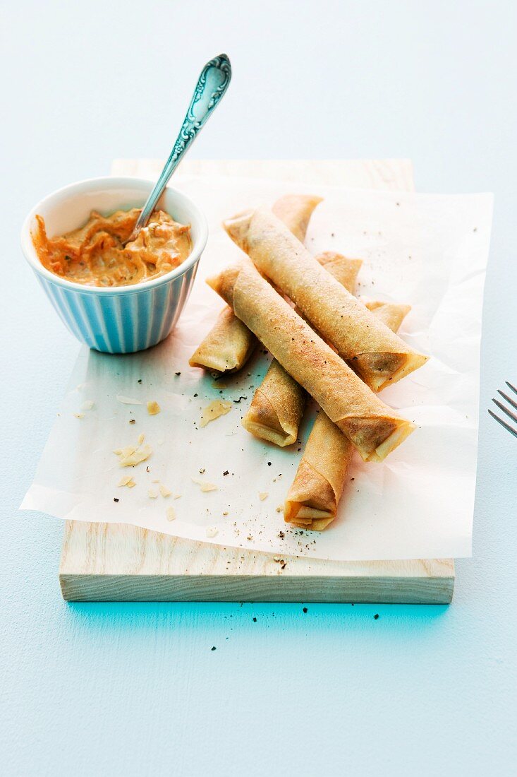 Fried filo dough rolls with tomato-basil dip