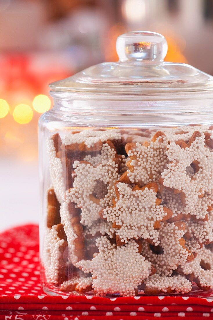 Christmas cookies with sugar pearls in a glass storage jar