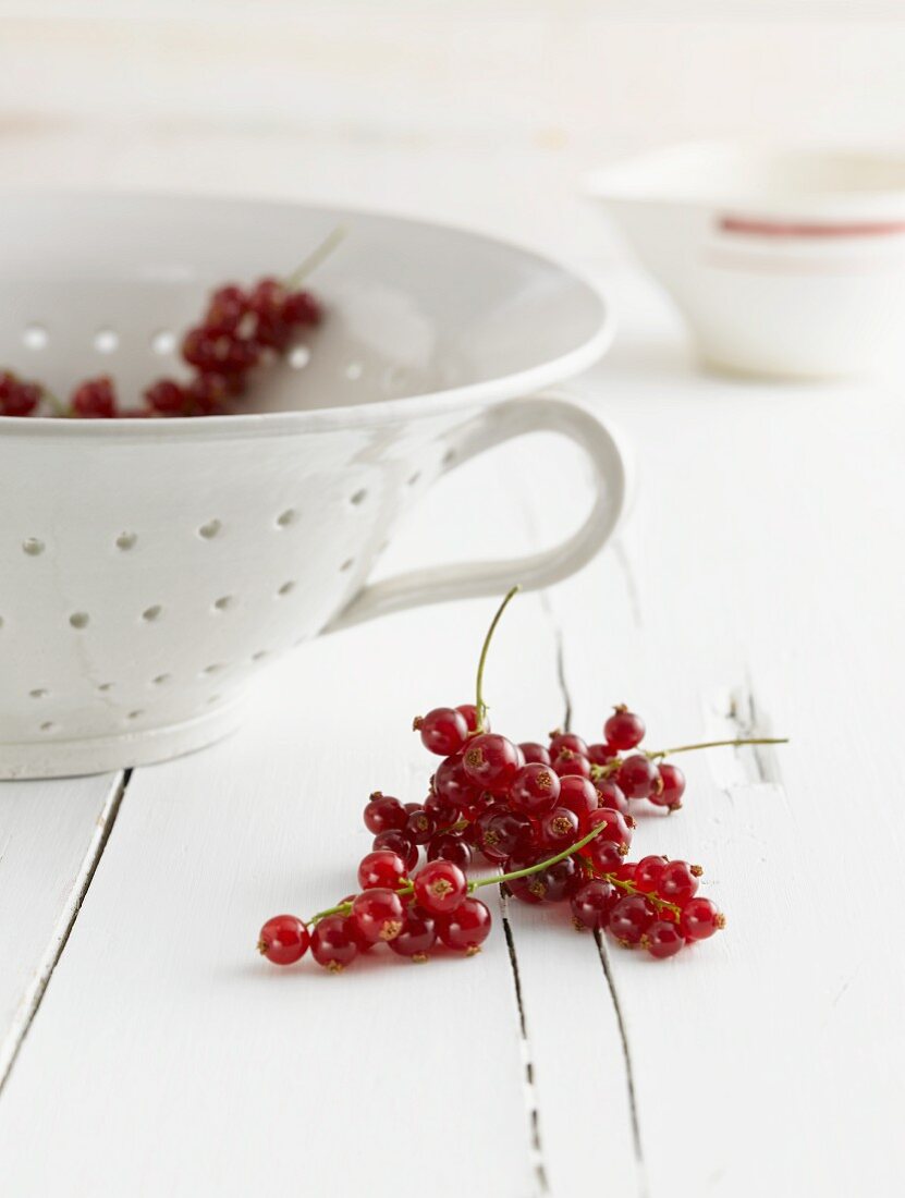 Redcurrants, some in a colander